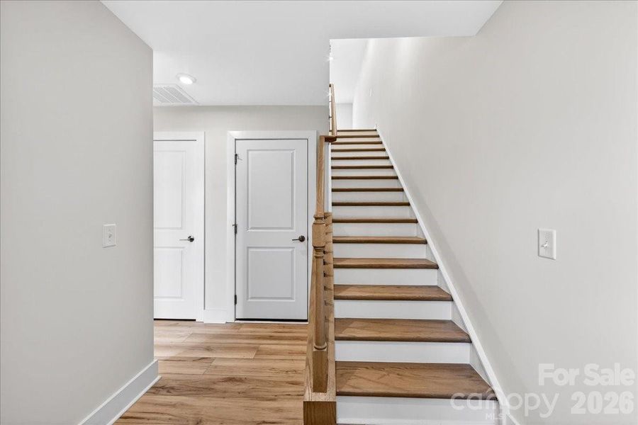 Foyer with oak box stairs and open rails