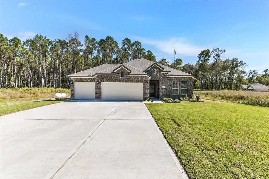 Front exterior of a new home in Encino Estates, Dayton, TX, highlighting curb appeal (Image 1). Front exterior of a new home in Encino Estates, Dayton, TX, highlighting curb appeal (Image 1).