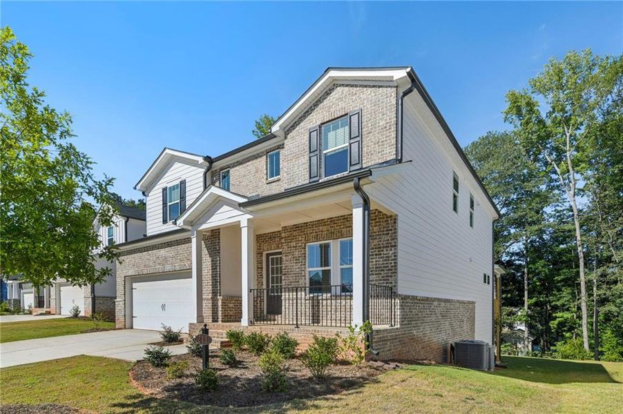 Front exterior of a new home in Martin Springs - Estate Series, Lawrenceville, GA, highlighting curb appeal (Image 23). Front exterior of a new home in Martin Springs - Estate Series, Lawrenceville, GA, highlighting curb appeal (Image 23).