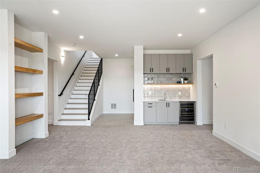 Full walk-out basement with family area, wet bar, wine storage, powder room, 2 bedrooms each with a private bath + gym/studio