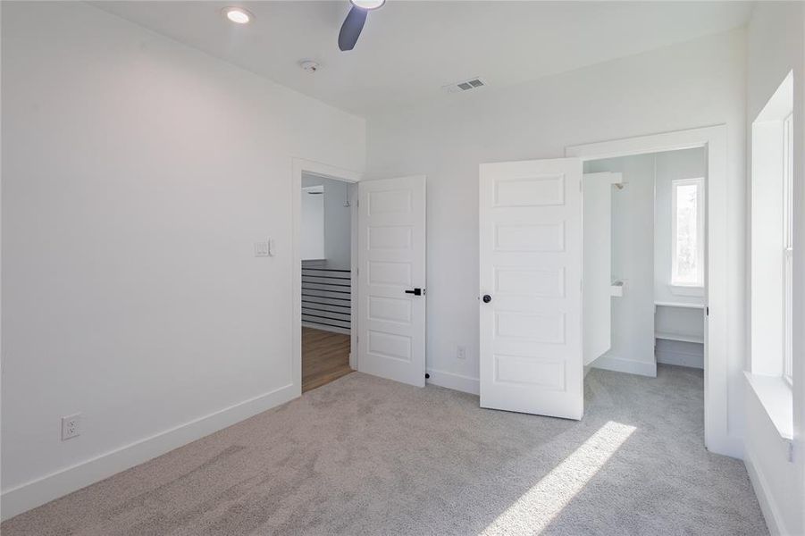 3rd bedroom featuring light colored carpet and ceiling fan 3rd bedroom featuring light colored carpet and ceiling fan