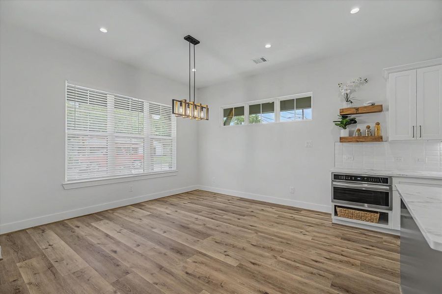 Bright and airy dining area featuring abundant natural light and modern finishes.