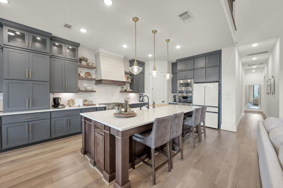 The gourmet kitchen combines style and function with premium Café appliances and designer finishes. A tankless water heater, Energy Star appliances, and LED lighting add modern efficiency to everyday living.