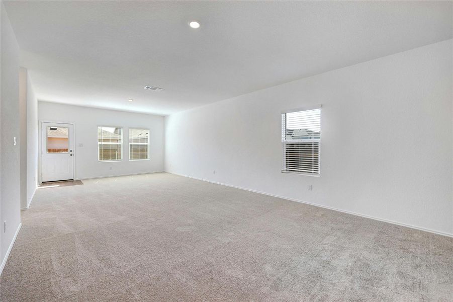 Empty room featuring light carpet and recessed lighting
