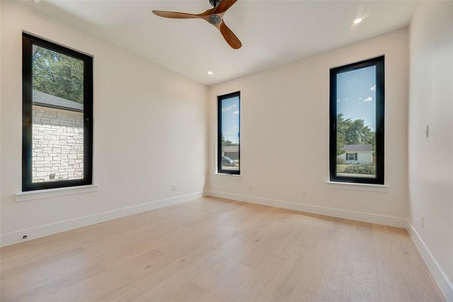 Unfurnished room featuring ceiling fan and light hardwood / wood-style flooring