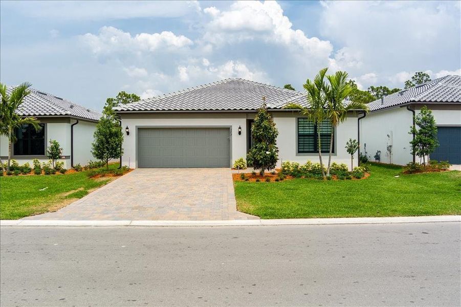 Front exterior of a new home in , Port St. Lucie, FL, highlighting curb appeal (Image 16). Front exterior of a new home in , Port St. Lucie, FL, highlighting curb appeal (Image 16).