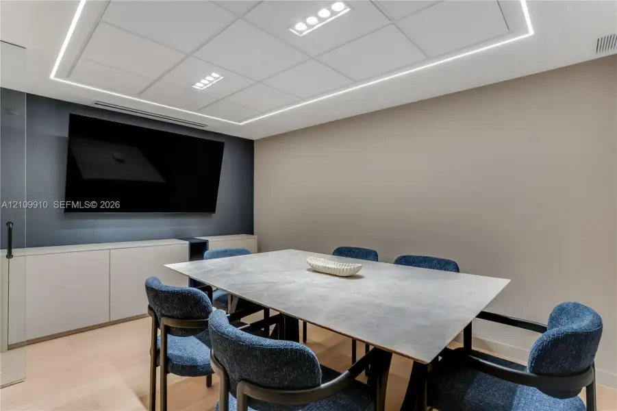 Built-in wall-to-wall cabinetry, recessed ceiling lighting with perimeter illumination, and light-toned wood-finish flooring