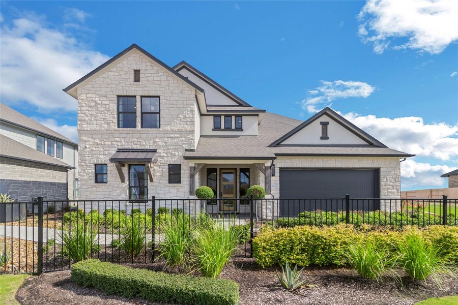 View of front of property with stone siding, an attached garage, and a shingled roof View of front of property with stone siding, an attached garage, and a shingled roof