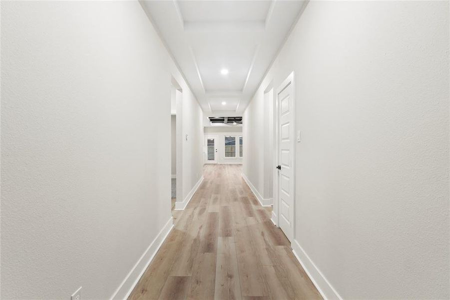 Hallway with light wood-style floors and recessed lighting Hallway with light wood-style floors and recessed lighting
