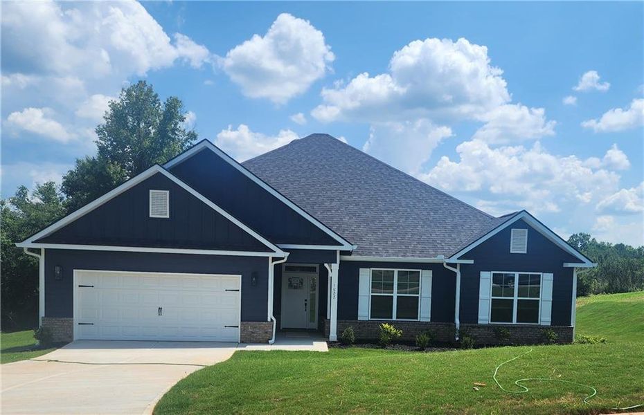 Front exterior of a new home in Holliday Pass, Griffin, GA, highlighting curb appeal (Image 1). Front exterior of a new home in Holliday Pass, Griffin, GA, highlighting curb appeal (Image 1).