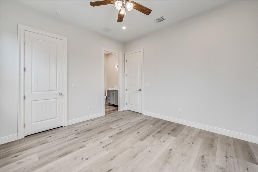 Unfurnished bedroom featuring light wood-type flooring and ceiling fan