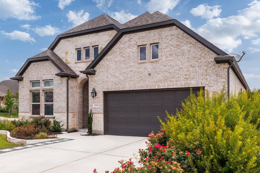 Front exterior of a new home in Parkside on the River, Georgetown, TX, highlighting curb appeal (Image 20). Front exterior of a new home in Parkside on the River, Georgetown, TX, highlighting curb appeal (Image 20).