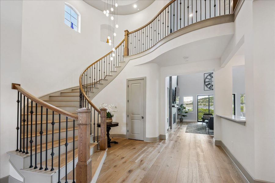 Wide Plank white oak flooring. Stunning chandelier greets you