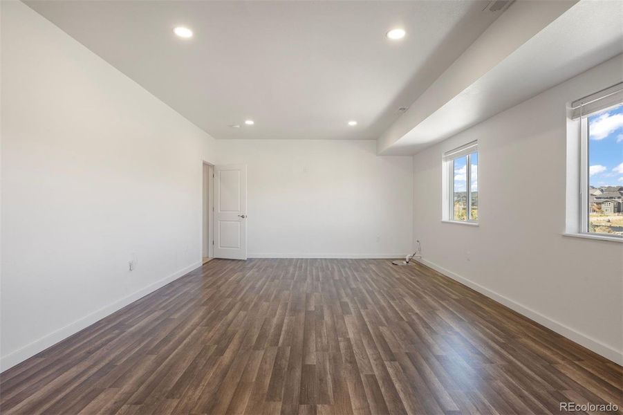 Expansive, newly finished basement living space with 8-foot ceilings.