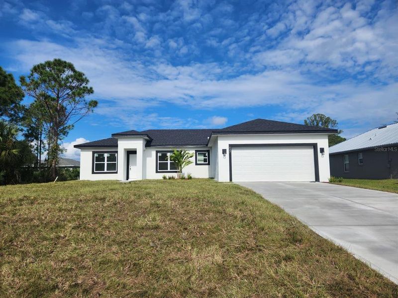 Front exterior of a new home in , Palm Bay, FL, highlighting curb appeal (Image 26). Front exterior of a new home in , Palm Bay, FL, highlighting curb appeal (Image 26).