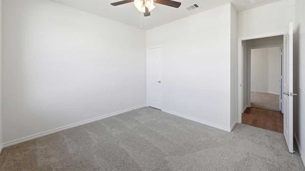 Unfurnished bedroom featuring carpet floors and ceiling fan Unfurnished bedroom featuring carpet floors and ceiling fan