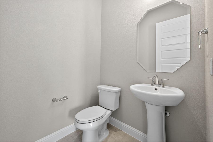 Half bath featuring a textured wall