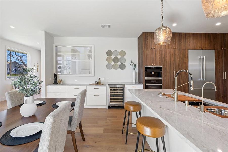 Elevate your entertaining experience with a dedicated wine refrigerator, adding a touch of sophistication to this modern kitchen.