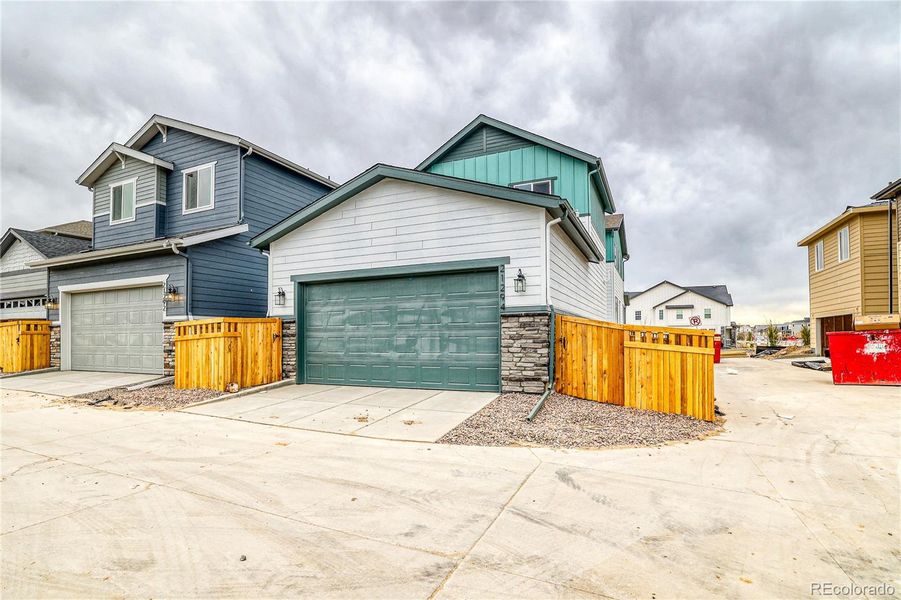 Front exterior of a new home in Painted Prairie, Aurora, CO, highlighting curb appeal (Image 1).