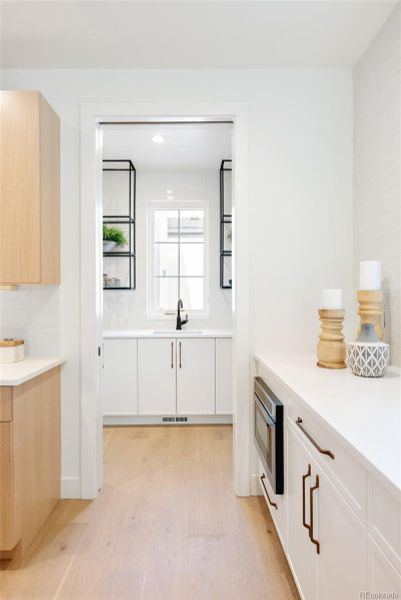 Butler's pantry with a window overlooking the backyard