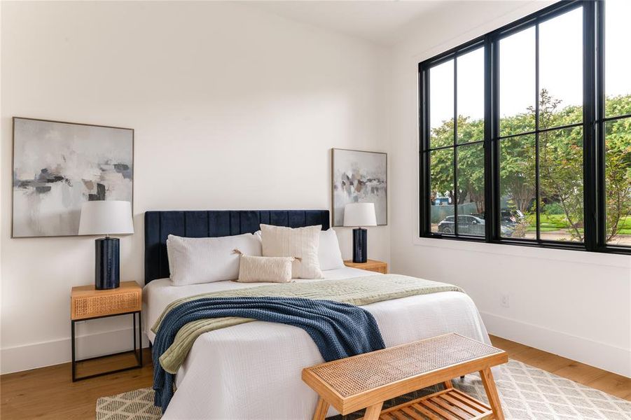 Bedroom featuring baseboards and wood finished floors