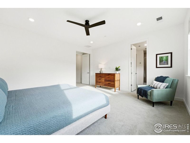 Spacious primary bedroom with en-suite bathroom- designed for comfort and quiet at the end of the day.