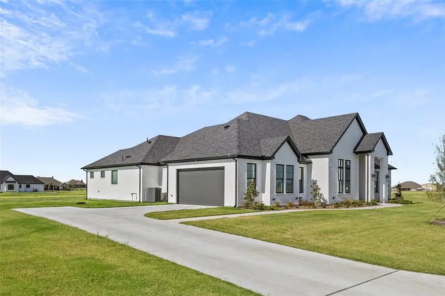 View of front of home featuring a garage and a front yard