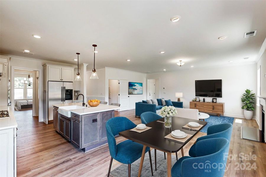 Breakfast area and family room shown with virtual staging