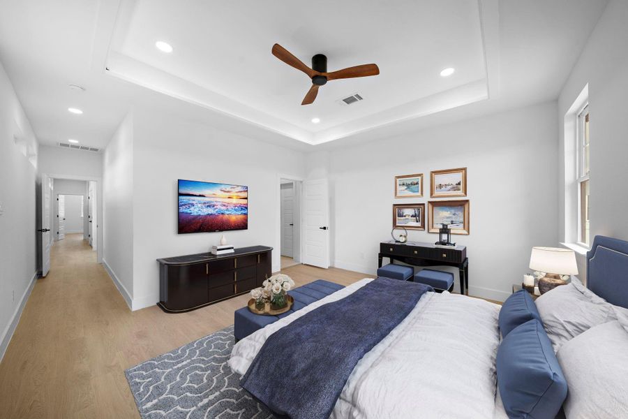 Staged photo of primary bedroom. Spacious and modern bedroom with sleek LVP floors, a ceiling fan, and ample natural light. Staged photo of primary bedroom. Spacious and modern bedroom with sleek LVP floors, a ceiling fan, and ample natural light.