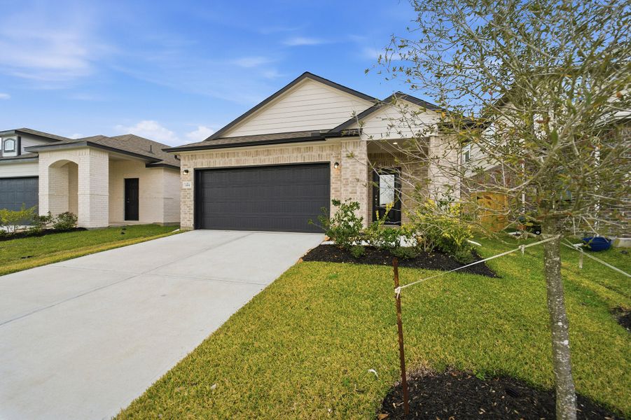 Front exterior of a new home in Windrose Green, Angleton, TX, highlighting curb appeal (Image 18).