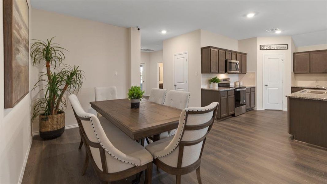 Dining area featuring dark wood finished floors and recessed lighting