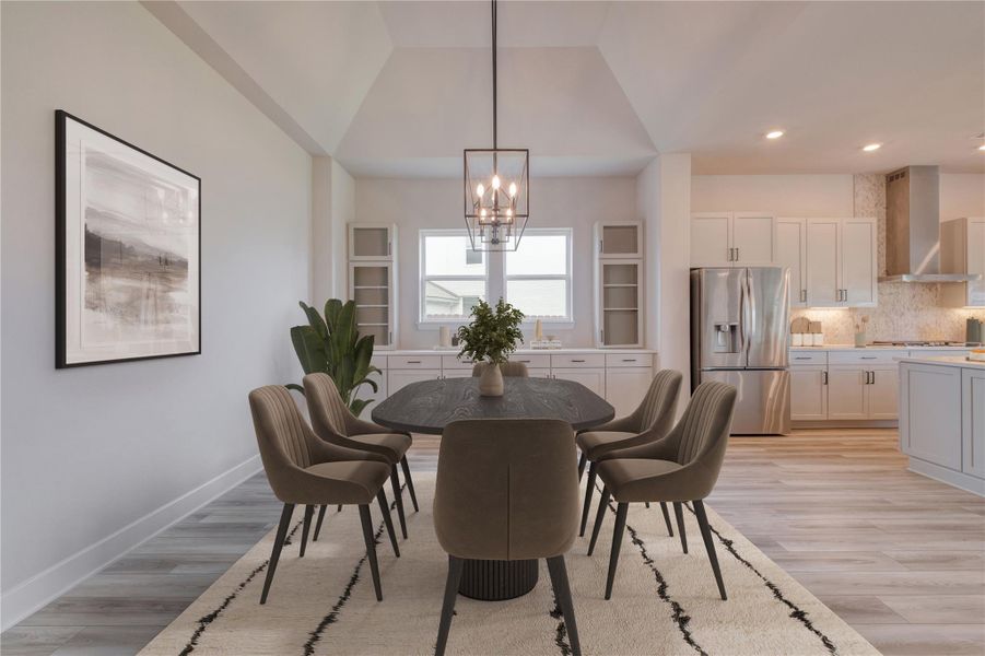 Dining area featuring vaulted ceilings, wood-finish flooring, and a contemporary chandelier