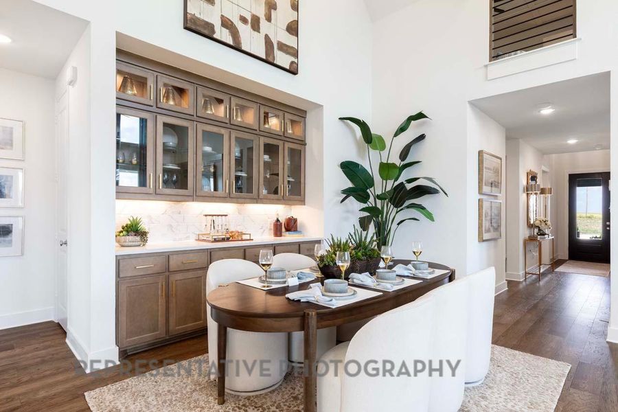 Dining area featuring dark wood finished floors and a towering ceiling Dining area featuring dark wood finished floors and a towering ceiling