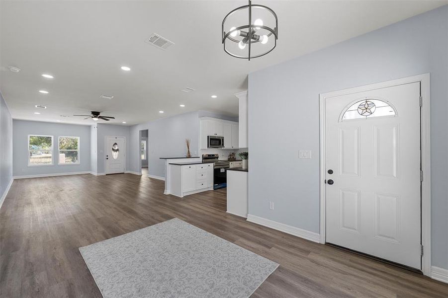 Foyer featuring recessed lighting, a ceiling fan, dark wood finished floors, and a chandelier