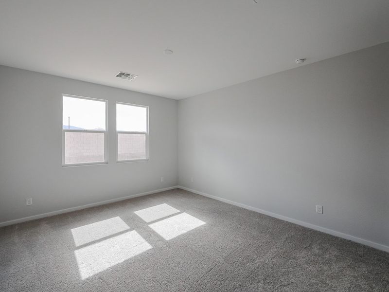 A room with a window and a rug.
