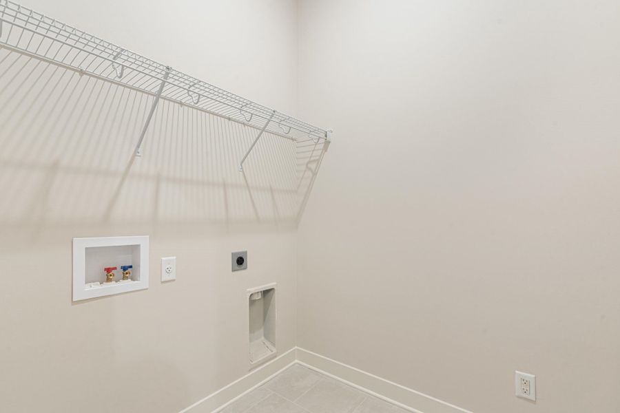 Neutral wall color, wire shelving, tile flooring, and utility hookups Neutral wall color, wire shelving, tile flooring, and utility hookups