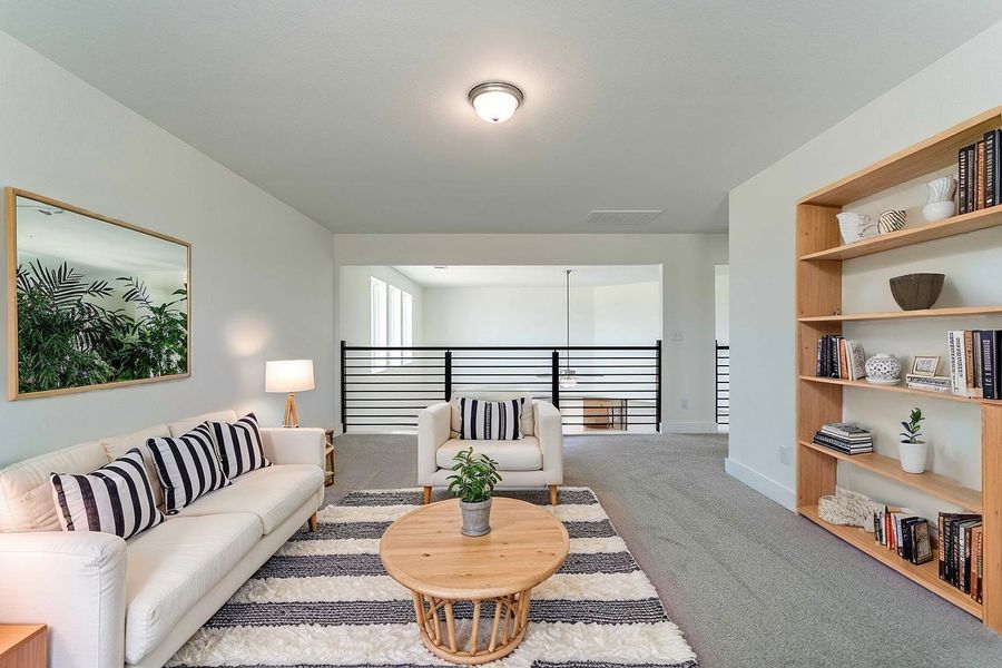 Loft-style overlook from the game room into the grand family room below, bringing in light and creating an airy, connected feel. **Image Representative of Plan Only and May Vary as Built**.