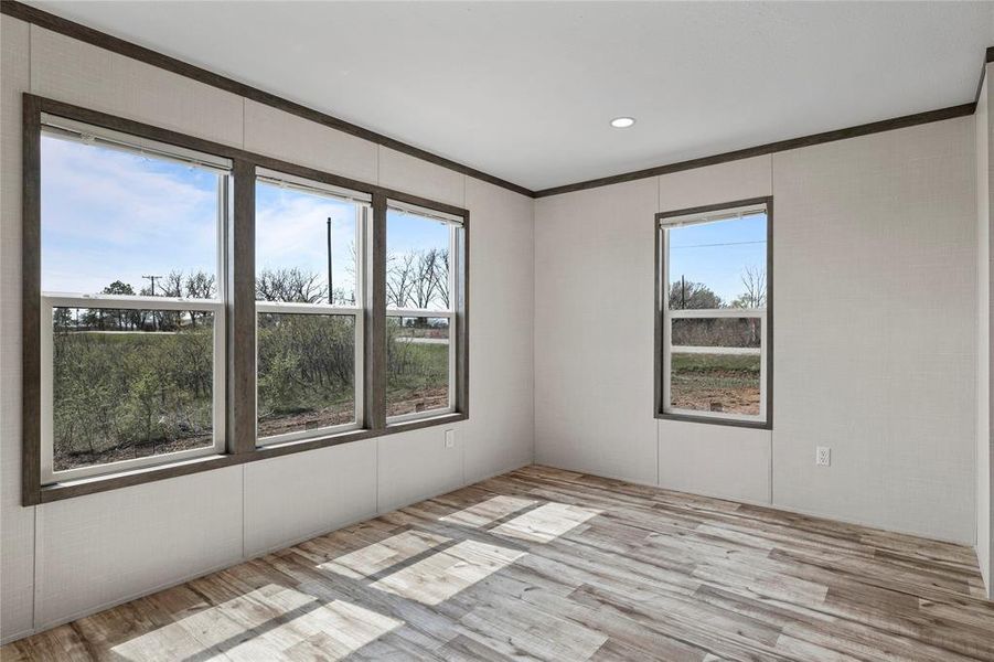 Unfurnished room with light wood-type flooring, ornamental molding, and recessed lighting
