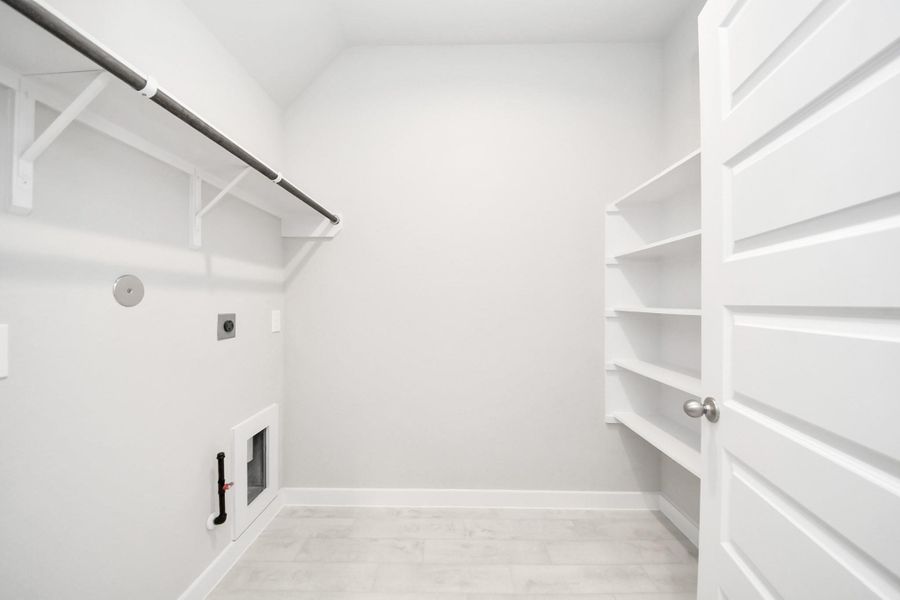 A perfect blend of functionality and comfort. Capture the essence of easy living with a first-floor laundry room, thoughtfully equipped with shelving for effortless organization. Both electric and gas connections available. A perfect blend of functionality and comfort. Capture the essence of easy living with a first-floor laundry room, thoughtfully equipped with shelving for effortless organization. Both electric and gas connections available.