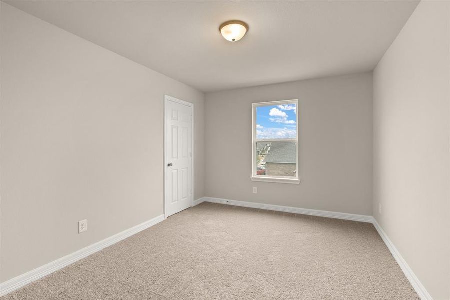 Your secondary bedroom features plush carpet, fresh paint, closet, and a large window that lets in plenty of natural lighting.