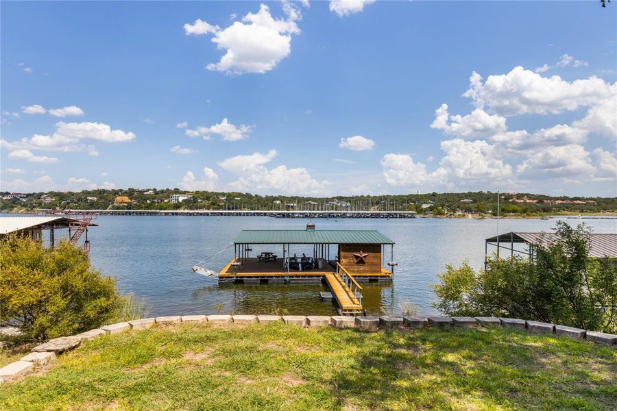 Dock featuring boat lift and a water view