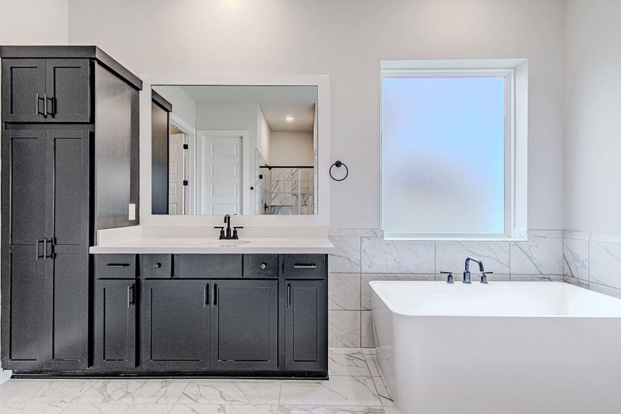 Spa-like bathroom featuring a soaking tub and elegant finishes.