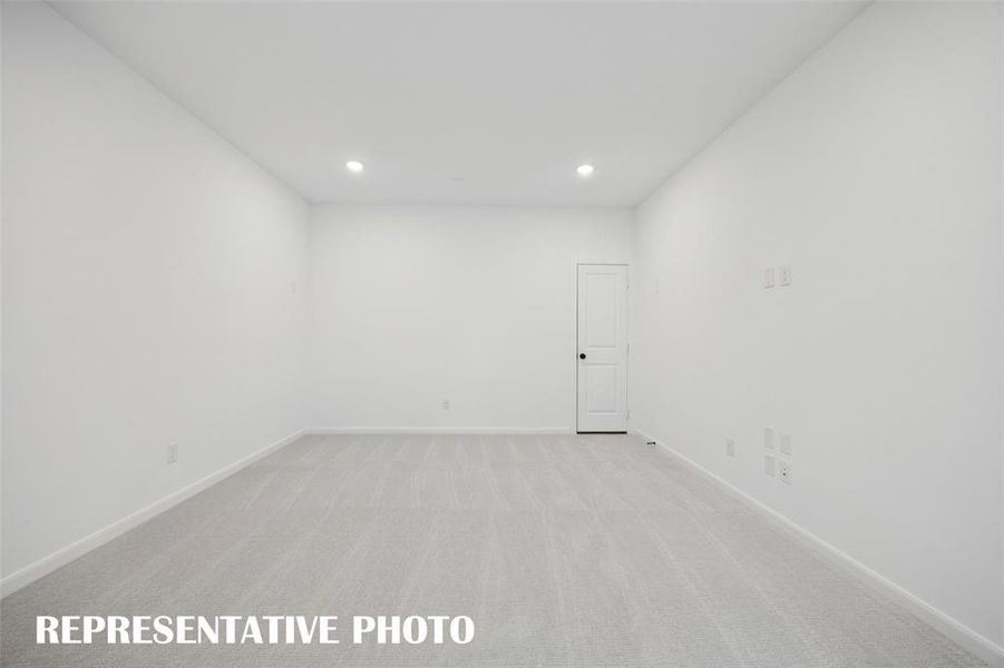 This spacious media room and adjacent game room create the ultimate entertainment zone!  REPRESENTATIVE PHOTO