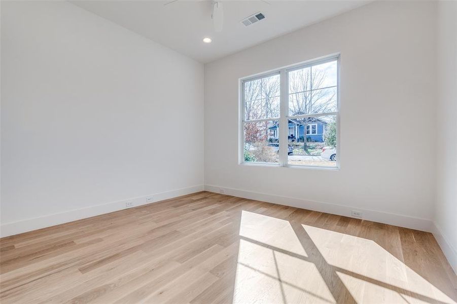 Empty room featuring ceiling fan and light hardwood / wood-style floors