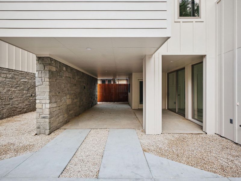 Entrance to property featuring stone siding, board and batten siding, and a patio area