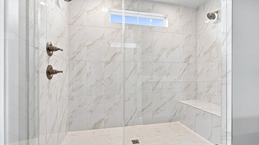 Highly functional and elegant en-suite with dual vanities, tiled walk-in shower, and refined finishes Highly functional and elegant en-suite with dual vanities, tiled walk-in shower, and refined finishes