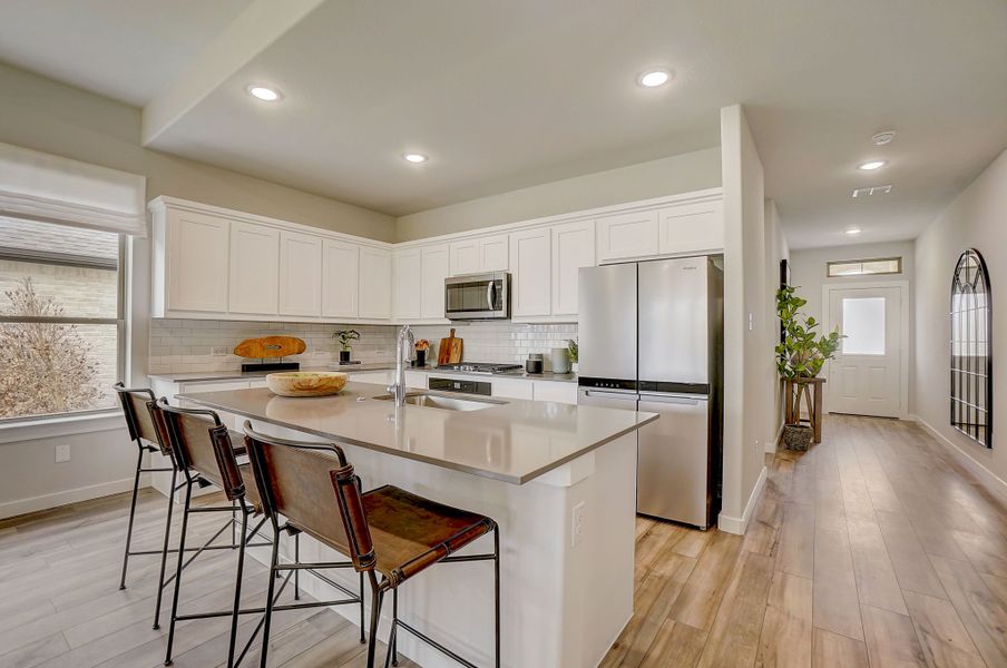 Kitchen in the Stanley II home plan by Trophy Signature Homes - REPRESENTATIVE PHOTO