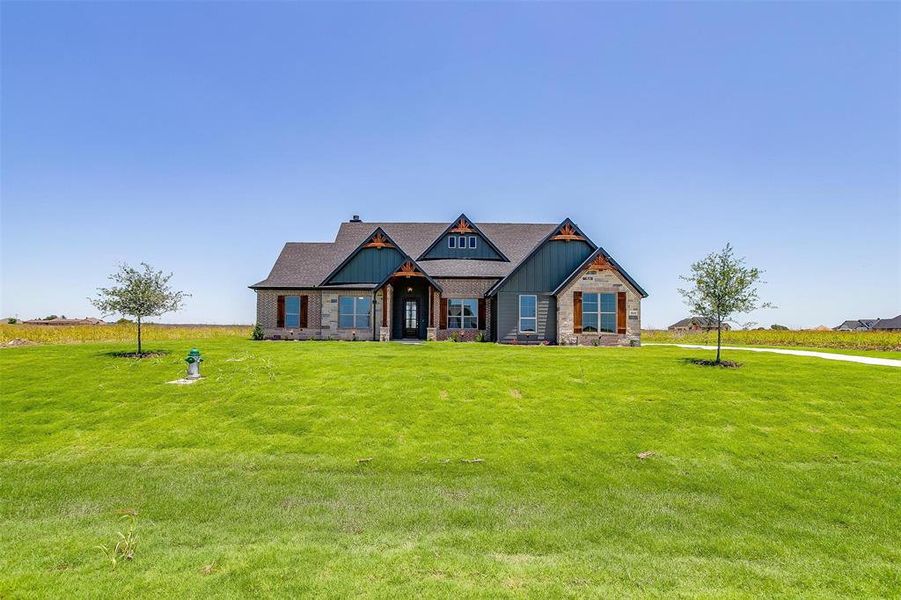 Craftsman inspired home with a front yard