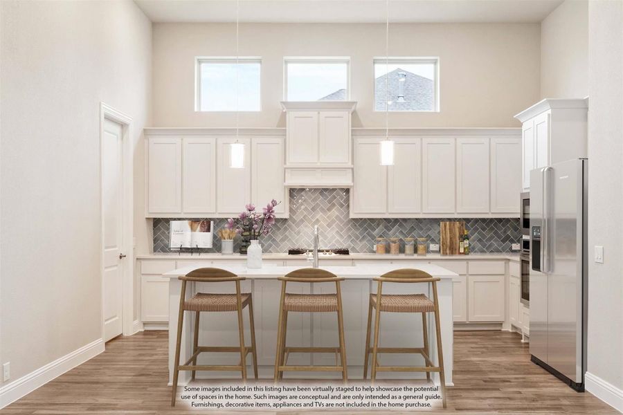 Kitchen with white cabinets, herringbone tile backsplash, center island with three bar stools, and stainless steel refrigerator.