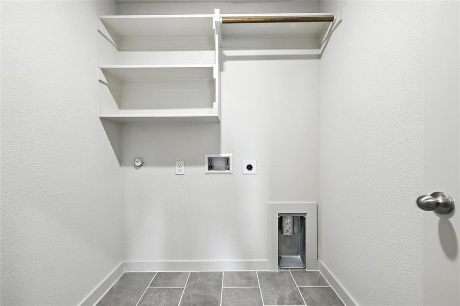 Laundry area with washer hookup, hookup for an electric dryer, and a textured wall Laundry area with washer hookup, hookup for an electric dryer, and a textured wall